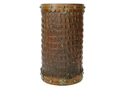 Lot 1416 - A crocodile skin stick stand with brass mounts.