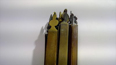 Lot 33 - A set of 14 brass stair rods. Width 68cm.