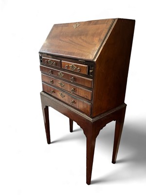 Lot 1704 - A miniature mahogany bureau on stand.