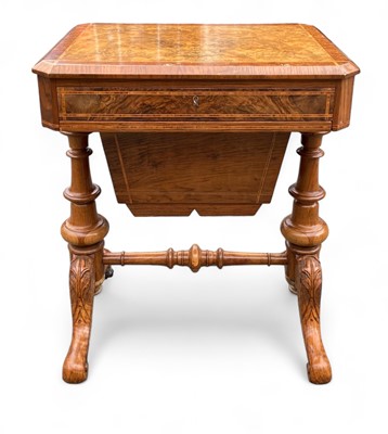 Lot 987 - A Victorian figured walnut and crossbanded sewing table.