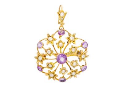 Lot 9 - An Edwardian 9ct amethyst and seed pearl set brooch pendant.