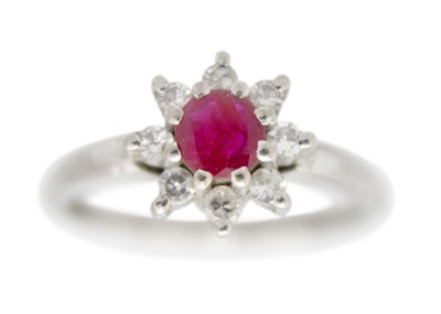 Lot 14 - A 14ct white gold ruby and diamond set cluster ring with matching stud earrings.