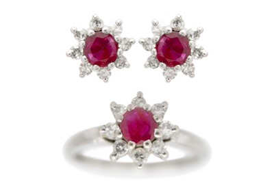 Lot 14 - A 14ct white gold ruby and diamond set cluster ring with matching stud earrings.