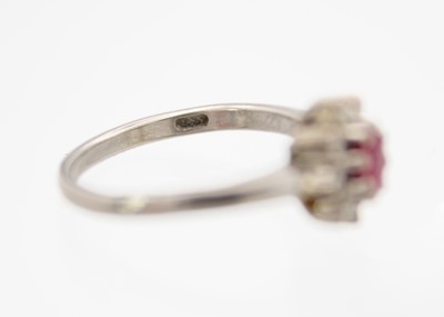 Lot 14 - A 14ct white gold ruby and diamond set cluster ring with matching stud earrings.
