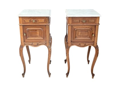 Lot 983 - A pair of French walnut and marble top beside cabinets.