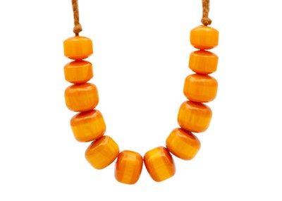 Lot 265 - A large butterscotch egg yolk amber bead necklace.