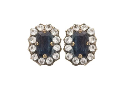 Lot 50 - A pair of blue and white sapphire cluster earrings.