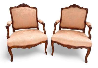 Lot 1677 - A pair of French walnut fauteuil armchairs