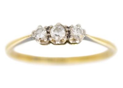 Lot 56 - An 18ct and platinum diamond set three-stone ring.