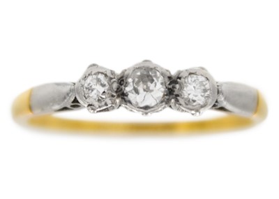 Lot 71 - An 18ct and platinum diamond set three-stone ring.