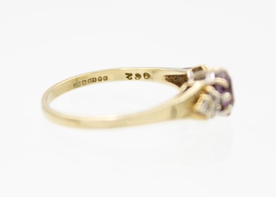 Lot 77 - A 9ct hallmarked gold diamond and amethyst set ring.