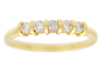 Lot 79 - An 18ct diamond set five-stone hoop ring.