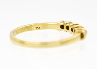 Lot 79 - An 18ct diamond set five-stone hoop ring.