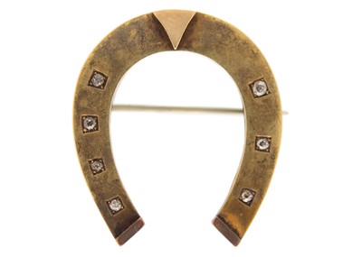 Lot 110 - A Victorian high-purity gold diamond set horseshoe brooch.