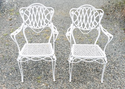 Lot 1566 - A pair of cast iron garden chairs.