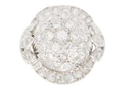 Lot 24 - A 14ct white gold diamond pavé set bombé ring.