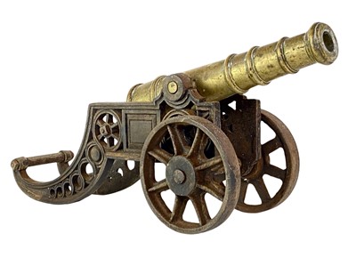 Lot 4 - A brass and iron model cannon.