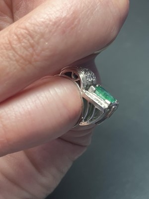 Lot 32 - A stylish Art Deco 18ct white gold emerald and diamond set dress ring.
