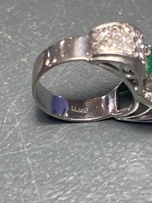 Lot 32 - A stylish Art Deco 18ct white gold emerald and diamond set dress ring.