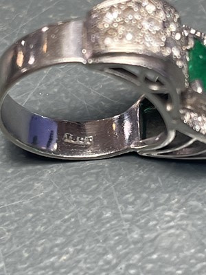 Lot 32 - A stylish Art Deco 18ct white gold emerald and diamond set dress ring.