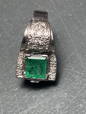 Lot 32 - A stylish Art Deco 18ct white gold emerald and diamond set dress ring.