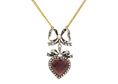 Lot 37 - A diamond, garnet and split pearl set heart and bow design pendant necklace.