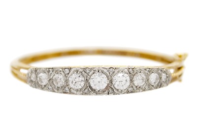 Lot 59 - A 9ct Edwardian style cubic zirconia set hinged bangle.