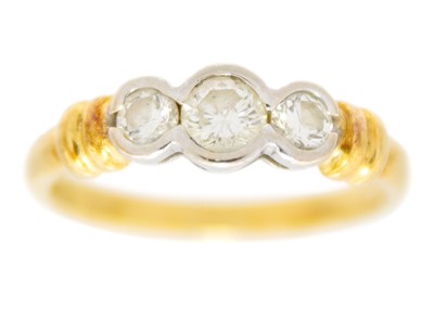 Lot 150 - A modern 18ct hallmarked yellow and white gold diamond set three-stone ring.