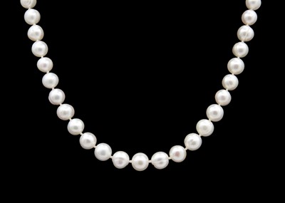 Lot 160 - A string of cultured white pearls with a 9ct ball clasp.