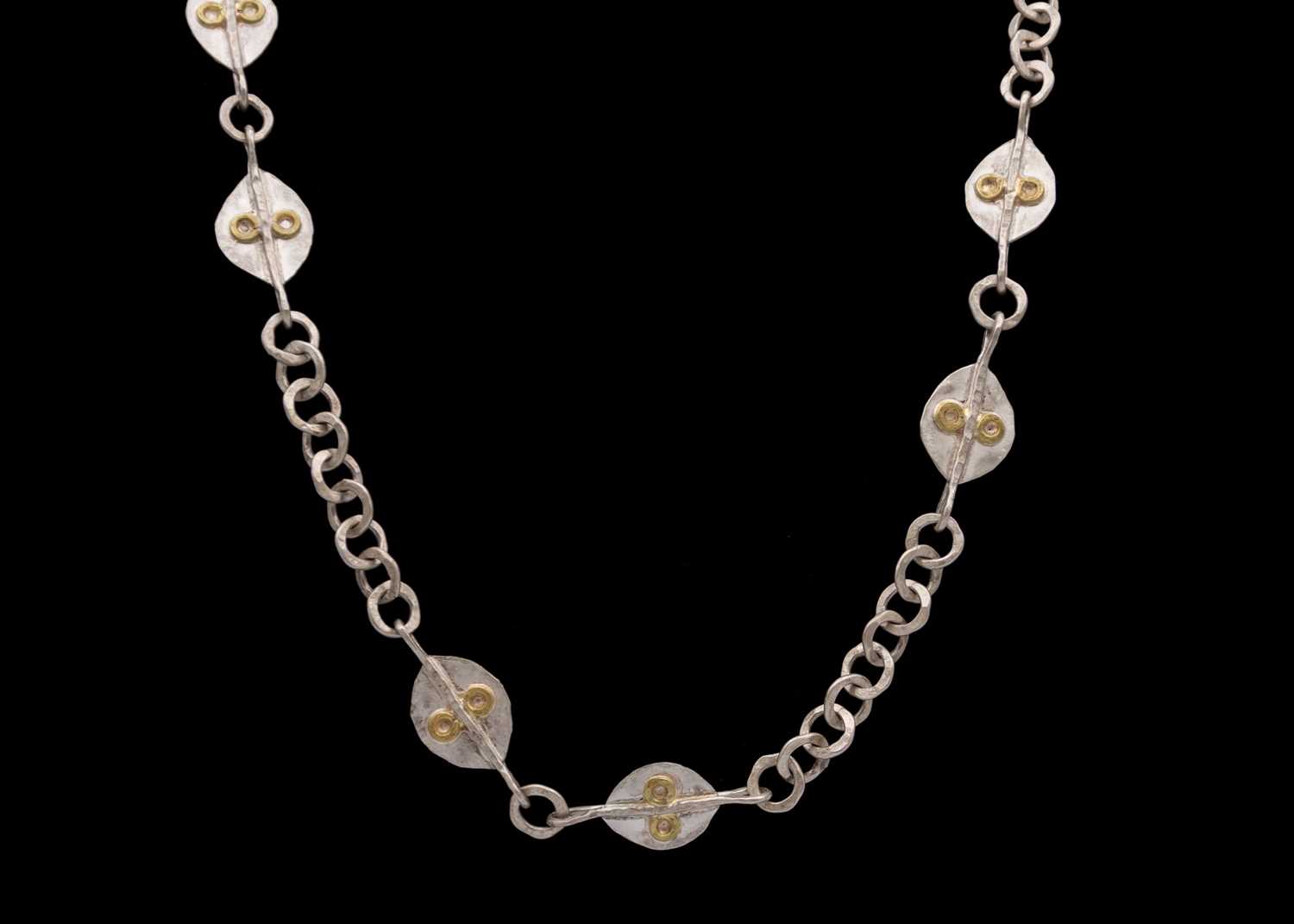 Lot 109 - GUY ROYLE - A silver and yellow metal applied necklace.