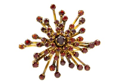 Lot 64 - A mid-century garnet set gold brooch.