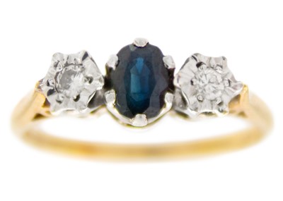 Lot 254 - A 9ct hallmarked diamond and sapphire set three-stone ring.