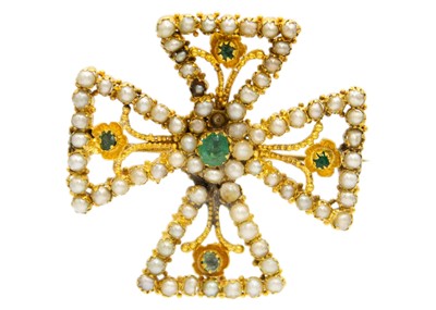 Lot 80 - A gold Byzantine Revival cross emerald and seed pearl set brooch.