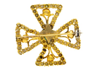 Lot 80 - A gold Byzantine Revival cross emerald and seed pearl set brooch.