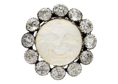 Lot 91 - A silver paste set 'man in the moon' brooch.