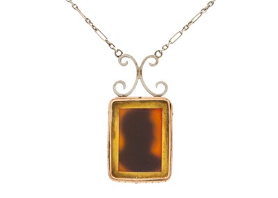 Lot 94 - A carved sardonyx cameo pendant necklace set in yellow and white gold.