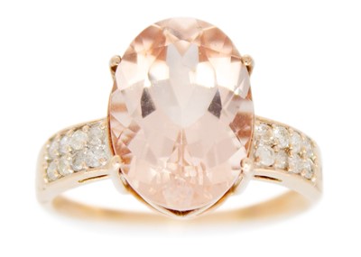 Lot 102 - A modern 9ct rose gold Morganite dress ring with diamond set shoulders.