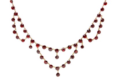 Lot 111 - A good 19th-century garnet swag and drop necklace in a rose gold closed-back setting.