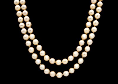 Lot 112 - A double row of uniform cultured pearls strung to a 14ct gold clasp set with pearls and emeralds.