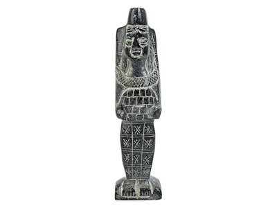 Lot 142 - An Egyptian carved black stone standing figure.