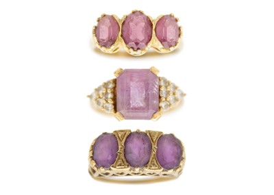 Lot 183 - Two 9ct amethyst set dress rings and a silver gilt amethyst set three stone ring.