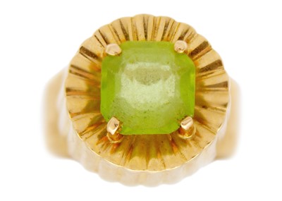 Lot 241 - An 18ct Modernist green garnet set dress ring.