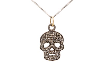 Lot 154 - A contemporary silver diamond set skull pendant on a silver chain.