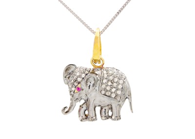 Lot 188 - An elephant pendant in yellow and white metal, set with diamonds and a ruby eye.