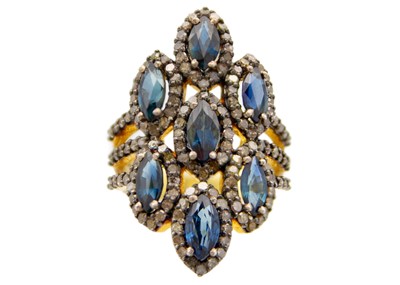 Lot 208 - A large silver gilt dress ring set with marquise cut sapphires and diamonds.