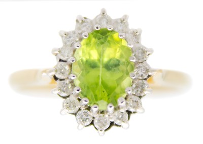 Lot 213 - A 9ct peridot and diamond set cluster ring.