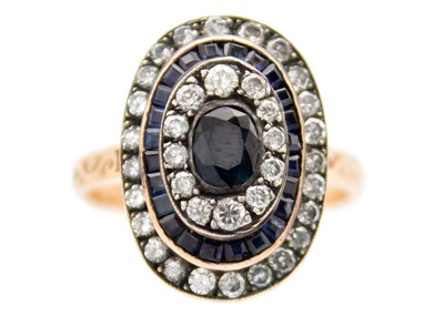 Lot 251 - A rose gold diamond and sapphire set target ring.