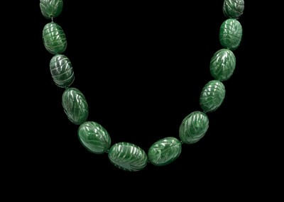 Lot 263A - A large and weighty carved reconstituted emerald bead necklace with a rose gold coloured T clasp.