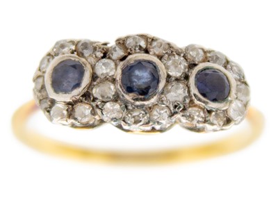 Lot 247 - An 18ct and platinum diamond and sapphire triple cluster ring.