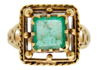 Lot 249 - An 18ct gold (tested) emerald set dress ring.